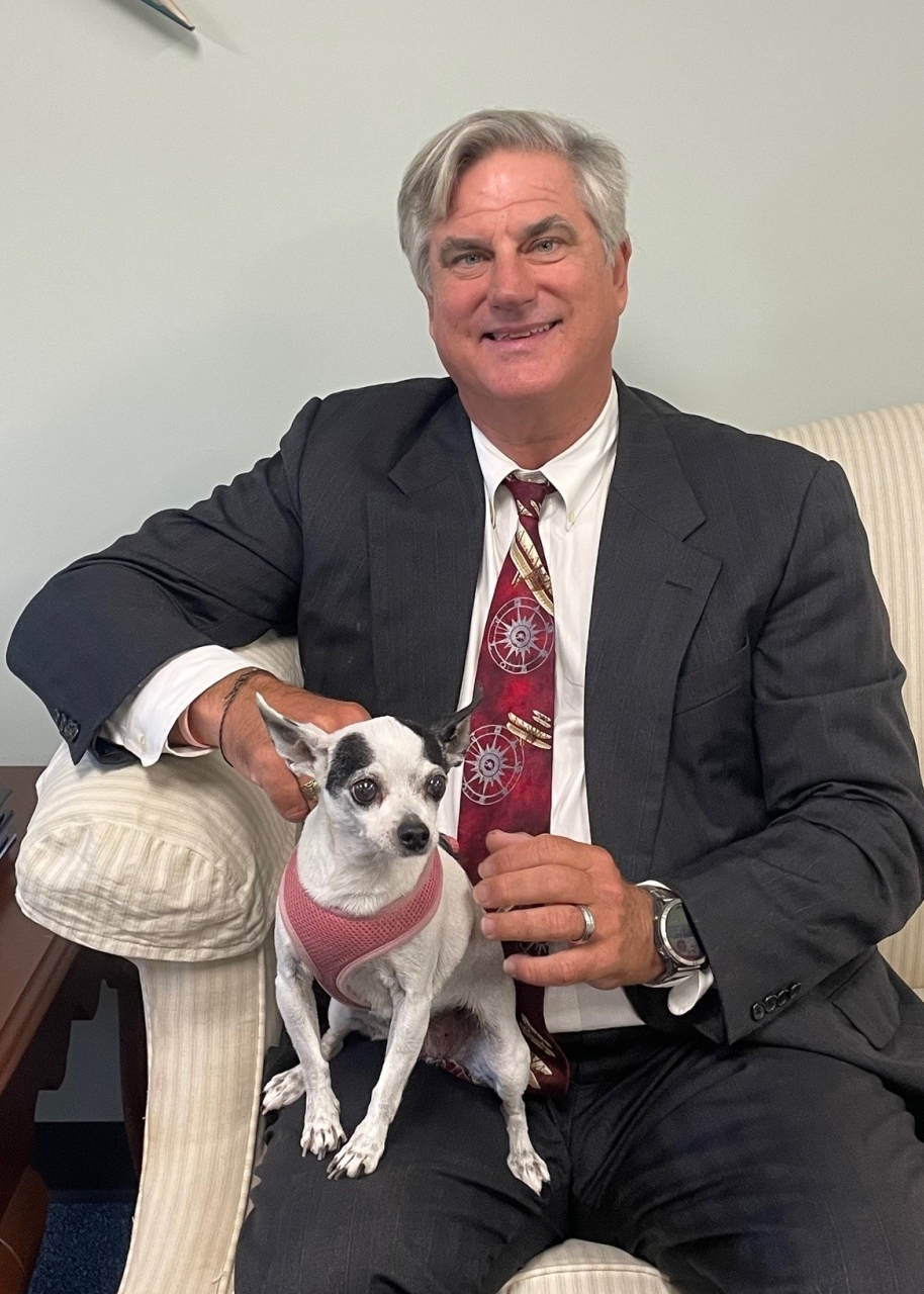John Macielag and pet dog sitting on couch together